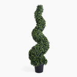 Artificial spiral topiary plant in a pot on a white background
