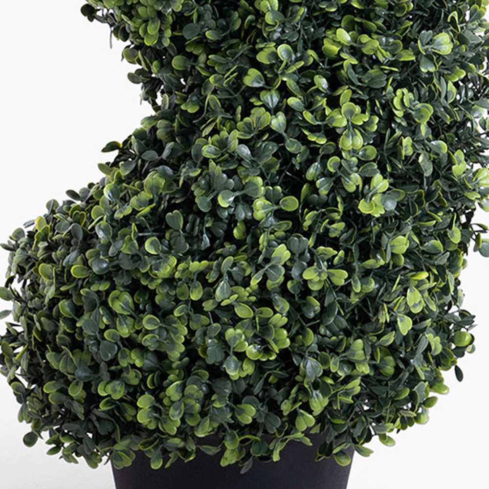 Artificial topiary ball plant in a pot on a white background