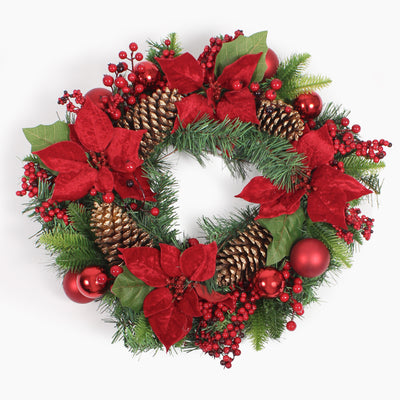 A festive Christmas wreath decorated with red poinsettias, gold pinecones, red berries, green pine branches, and red ornaments on a plain white background.