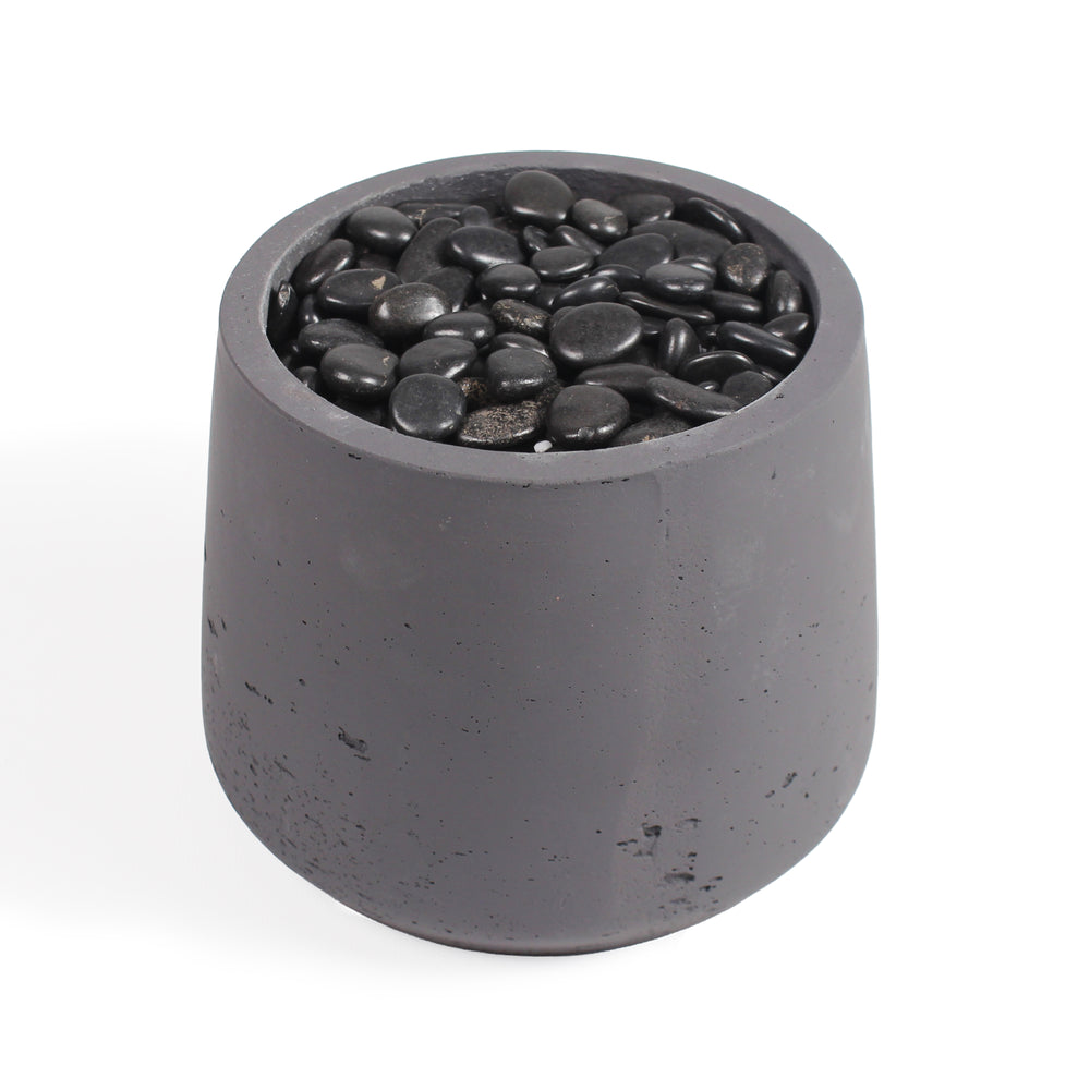 A dark gray concrete planter pot filled with smooth black decorative stones, shown on a clean white background.
