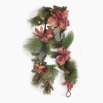 A Christmas garland featuring glittery green pine needles, silver eucalyptus leaves, and dusty pink poinsettia flowers with small gold pinecones, shown against a plain white background.