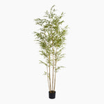 Artificial bamboo plant in a pot on a white background