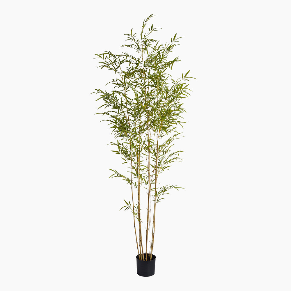 Artificial bamboo plant in a pot on a white background