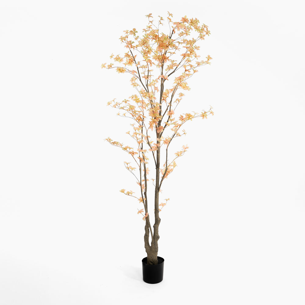 Artificial tree with orange leaves in a pot on a white background