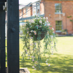 Hanging basket with flowers in a garden setting