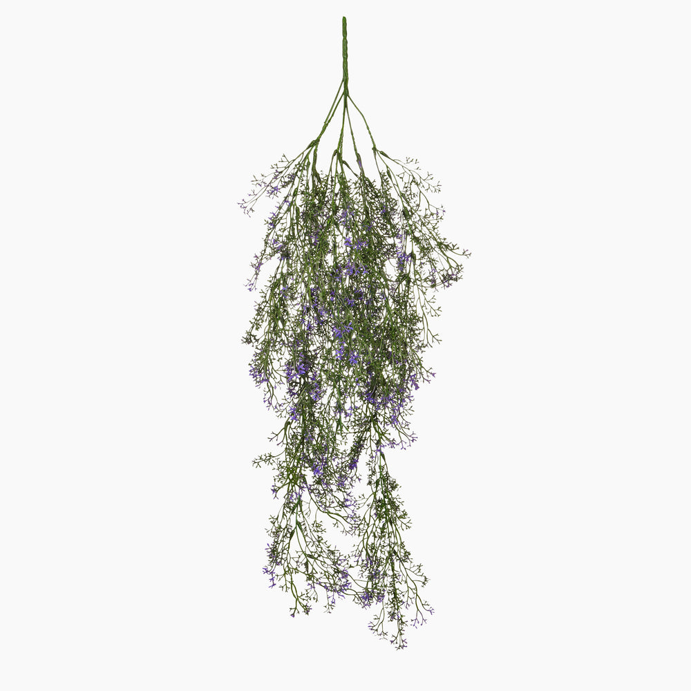 Hanging bundle of greenery with small purple flowers on a white background