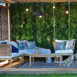 Outdoor patio with wooden furniture, swing, and greenery