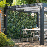 Outdoor patio area with a pergola, table, and chairs in a garden setting.