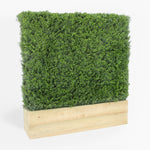 Artificial green wall panel with wooden base on a white background