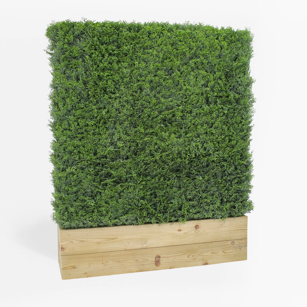 Artificial green wall panel with wooden base on a white background