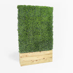 Artificial green wall panel in a wooden planter on a white background