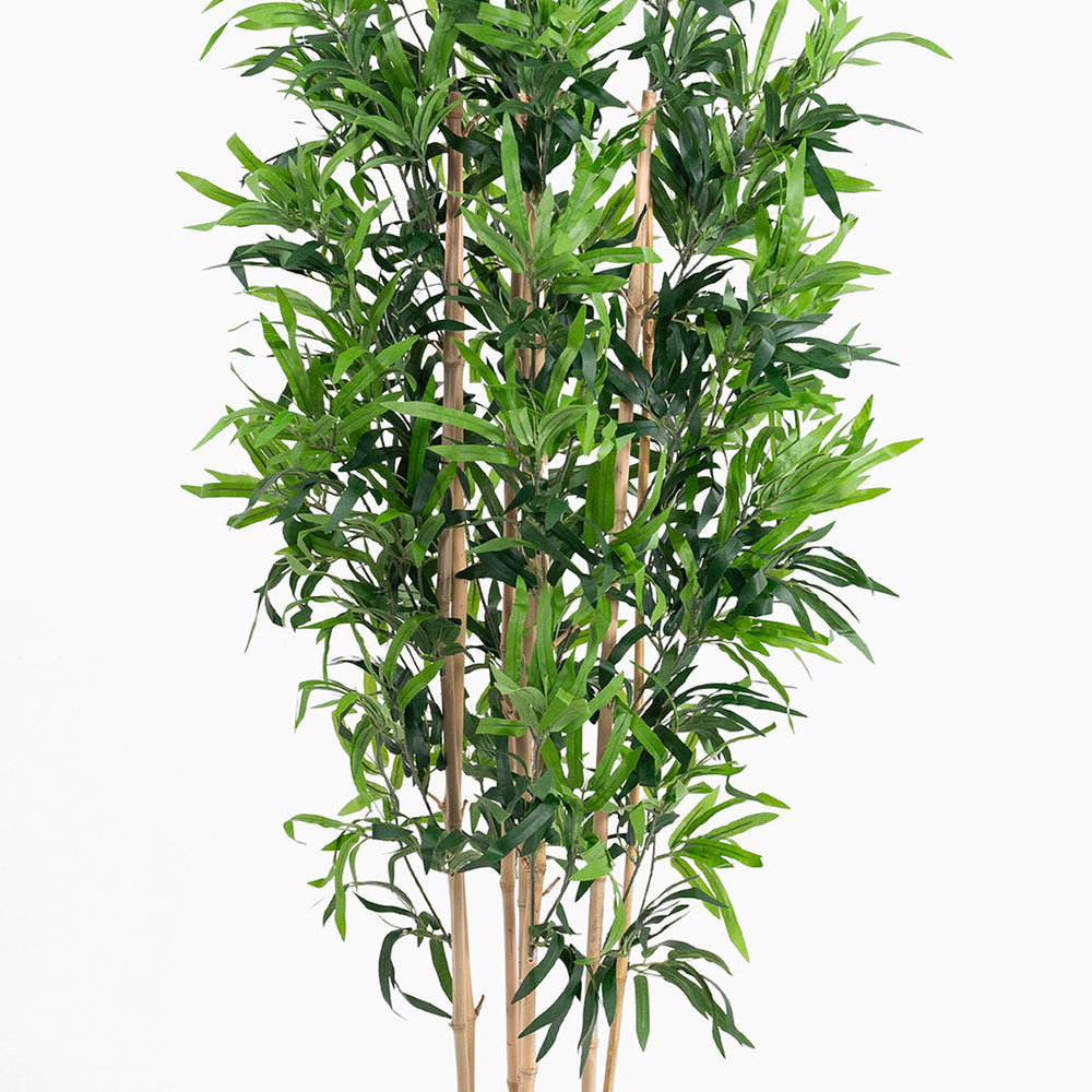 Artificial bamboo plant with green leaves on a white background