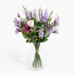 Bouquet of flowers in a clear vase on a white background