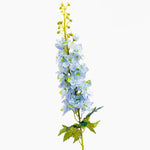 Artificial flower branch with blue flowers and green leaves on a white background