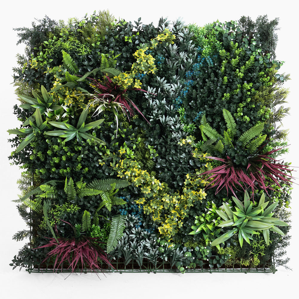 Artificial vertical garden wall with various green plants on a white background