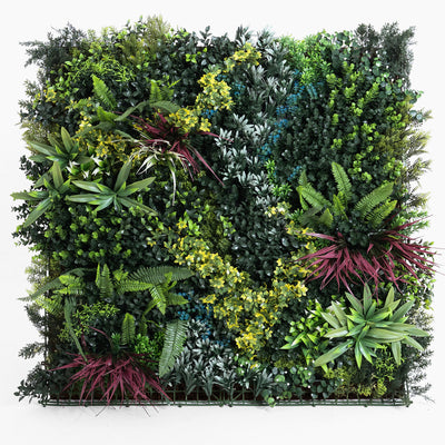 Artificial vertical garden wall with various green plants on a white background
