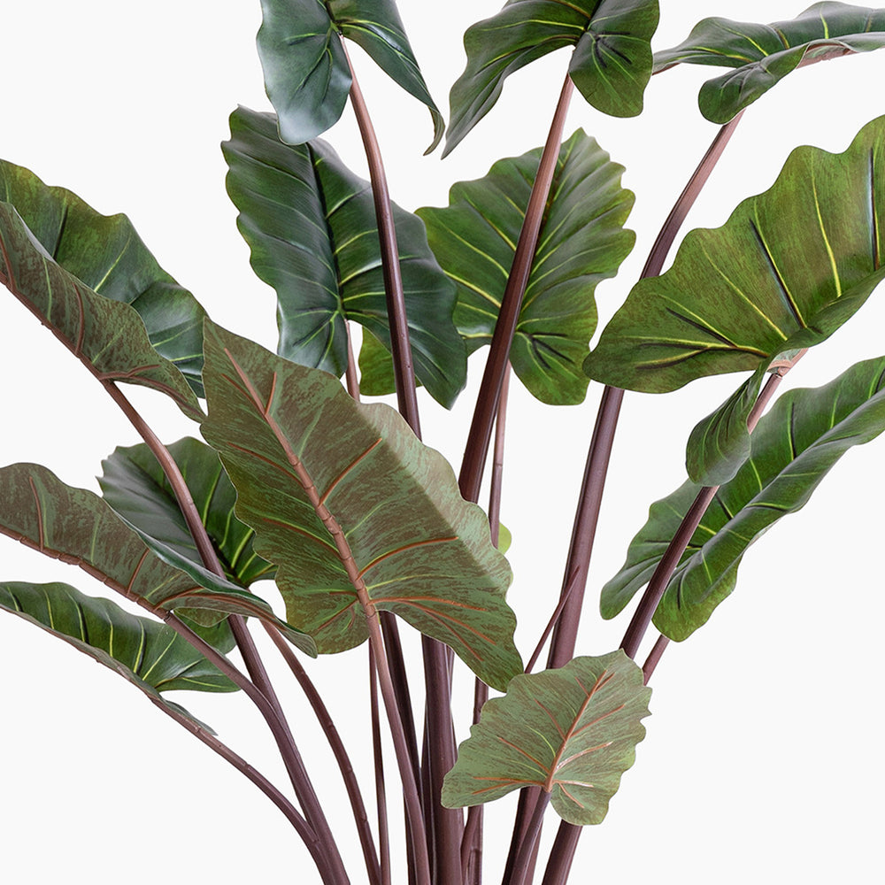 Artificial green leaves with brown stems on a white background