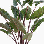 Artificial green leaves with brown stems on a white background