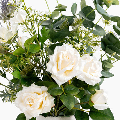 Bouquet of white roses and greenery on a white background