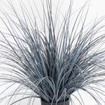 Faux potted plant with long, thin leaves on a white background