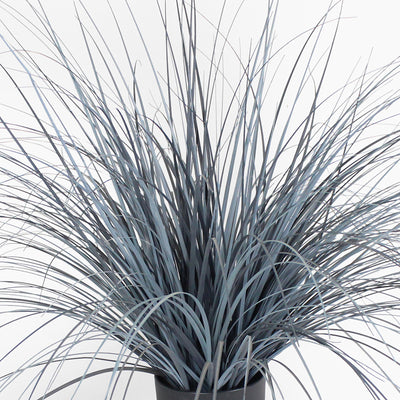 Faux potted plant with long, thin leaves on a white background