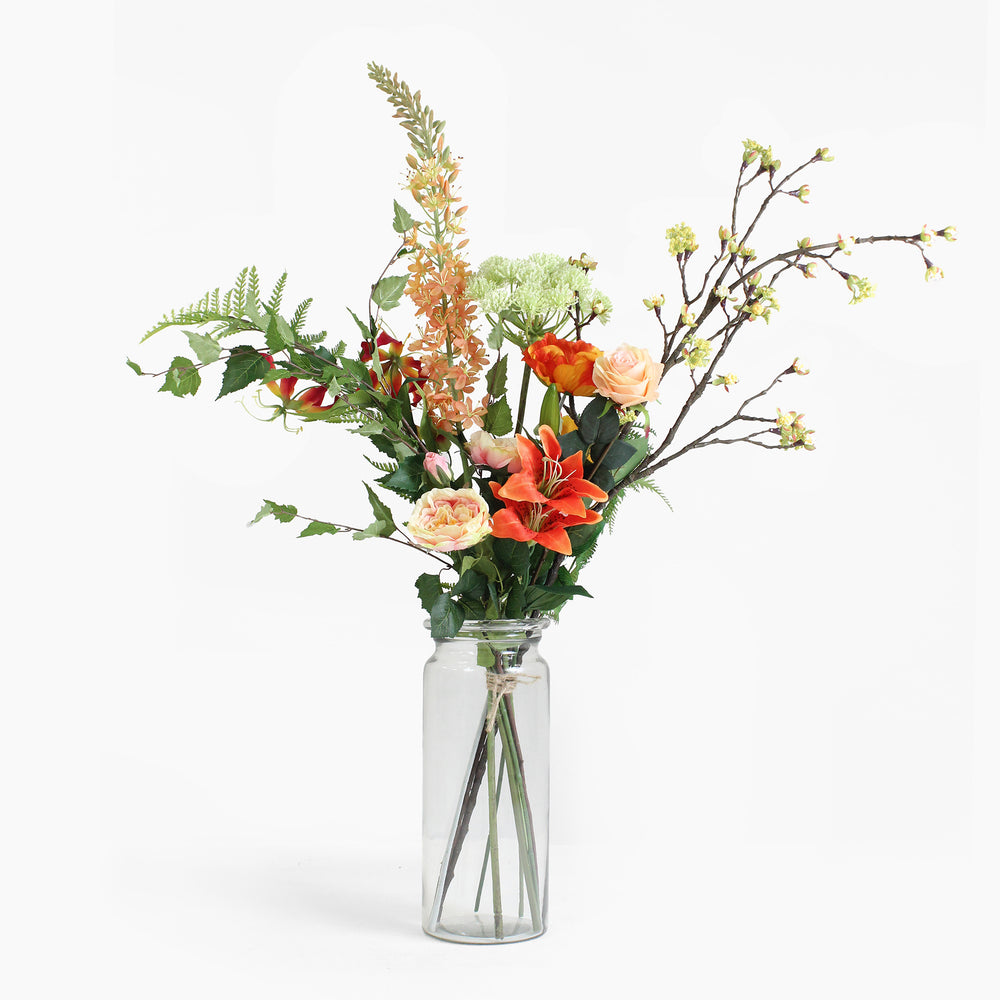 Bouquet of flowers in a clear glass vase on a white background