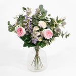 Bouquet of flowers in a clear vase on a white background