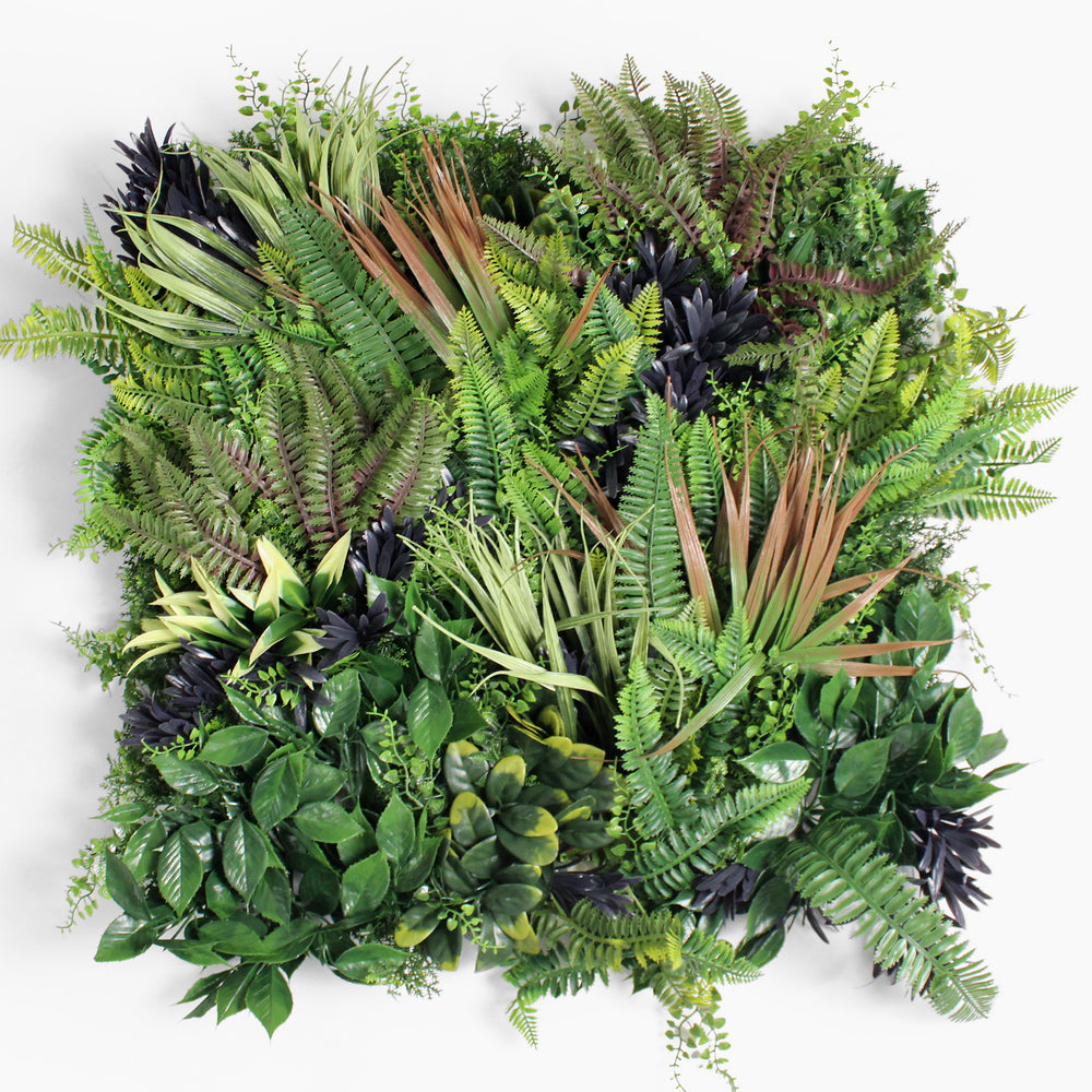 Artificial greenery arrangement with various types of leaves on a white background