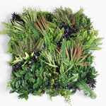 Artificial greenery arrangement with various types of leaves on a white background