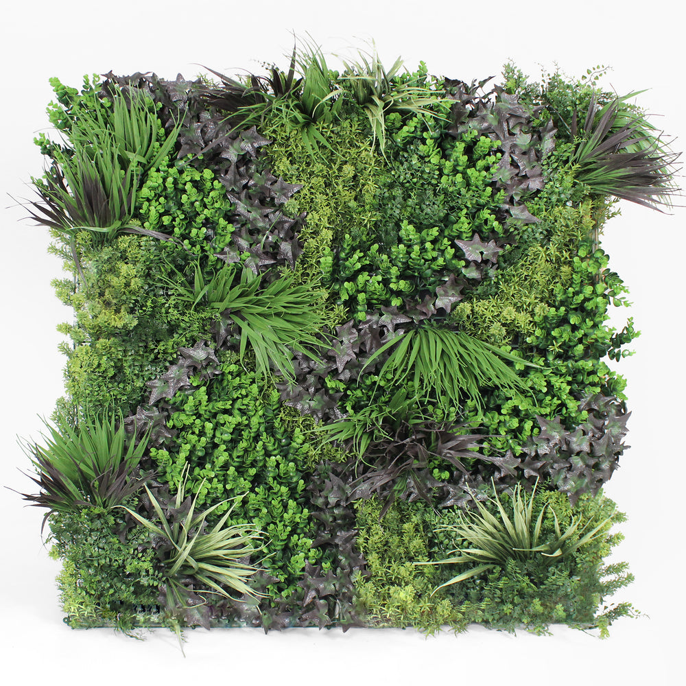 Artificial vertical garden wall with various green plants on a white background