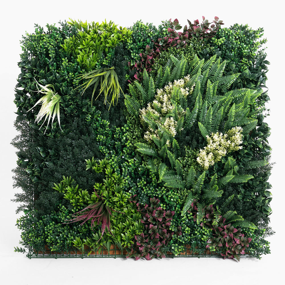 Artificial green wall with various green plants on a white background