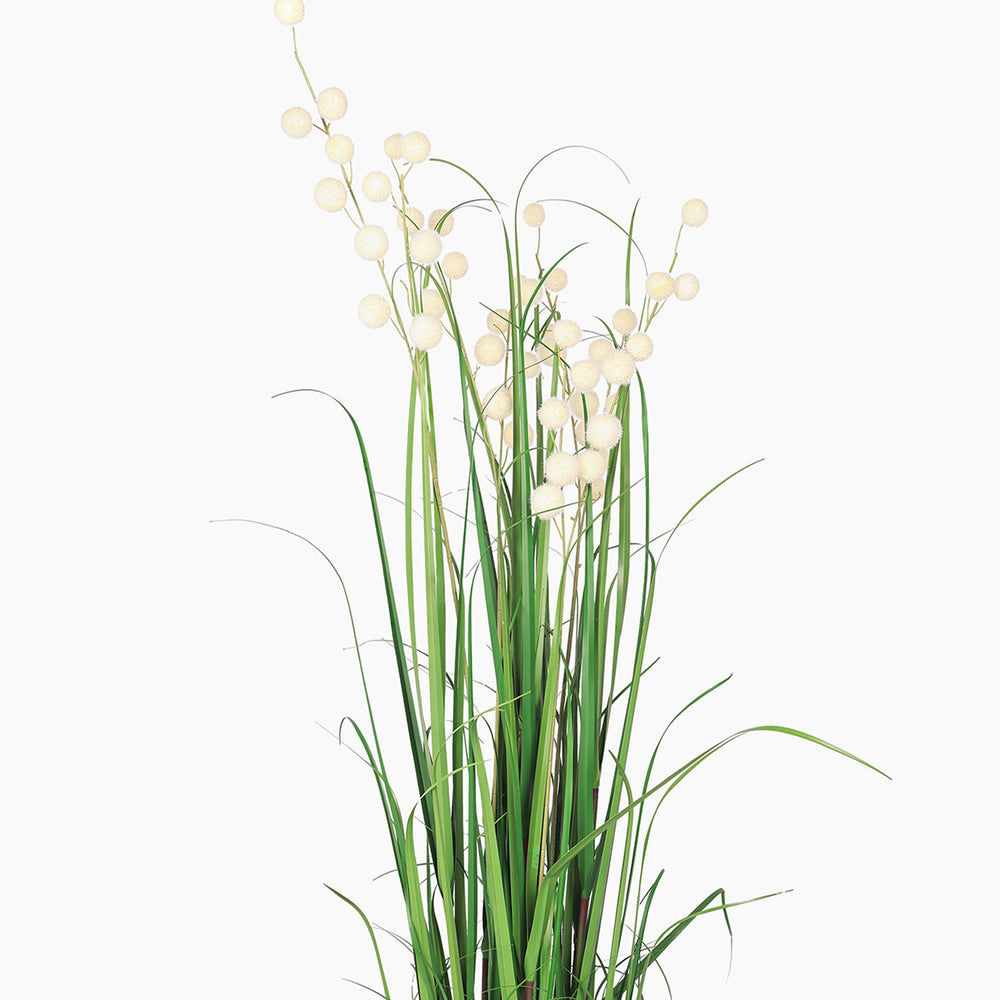 Artificial plant with green leaves and white berries on a white background