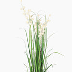 Artificial plant with green leaves and white berries on a white background