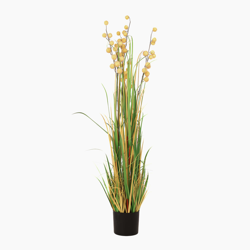 Artificial plant with yellow flowers and green leaves in a black pot on a white background