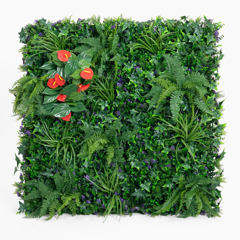 Artificial green wall with various plants and red flowers on a white background