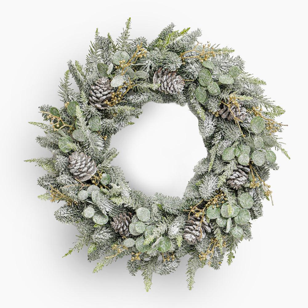 Christmas wreath with pine cones and snow effects on a white background