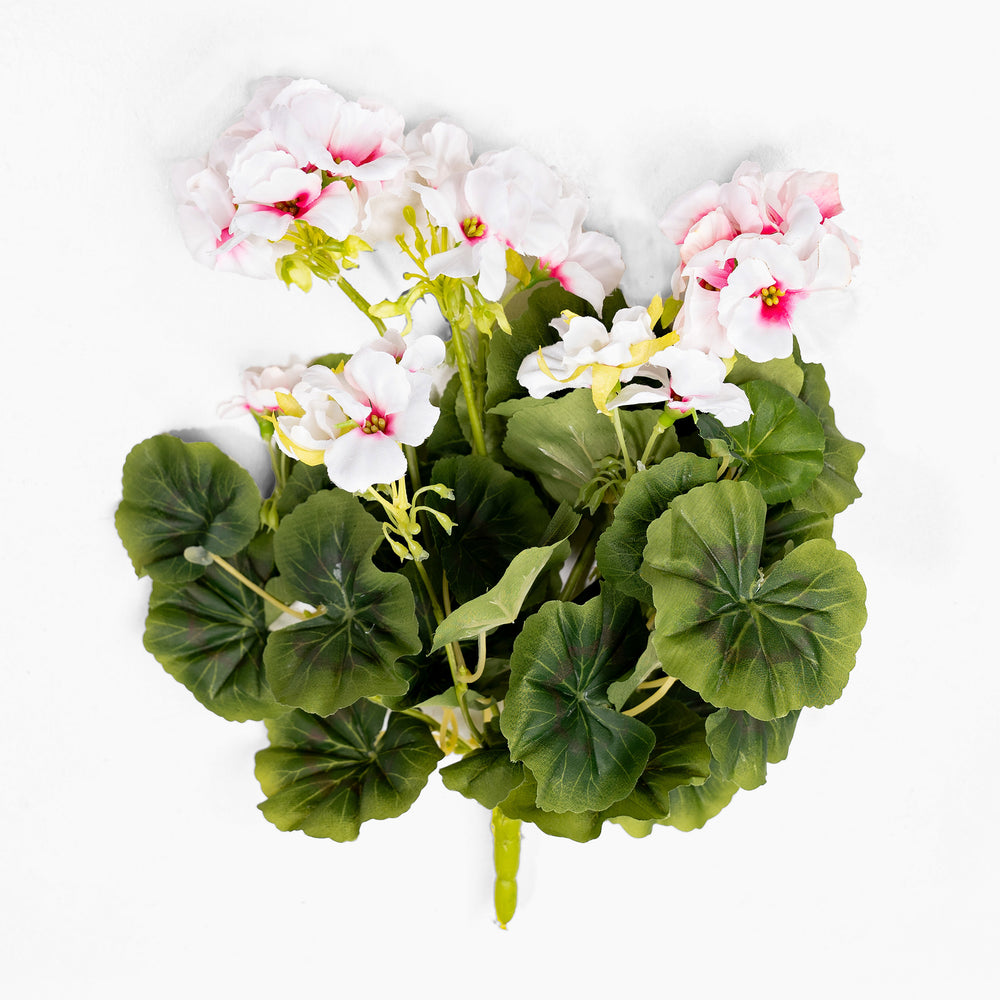 Artificial flower arrangement with white and pink flowers and green leaves on a white background