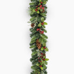 Christmas garland with greenery, berries, and pinecones on a white background