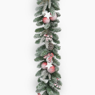Decorative Christmas garland with pink ornaments and pinecones on a white background