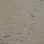 Close-up of a textured concrete surface with small stones and imperfections.