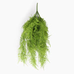 An artificial green fern bush hanging from a single spike, shown against a plain white background.