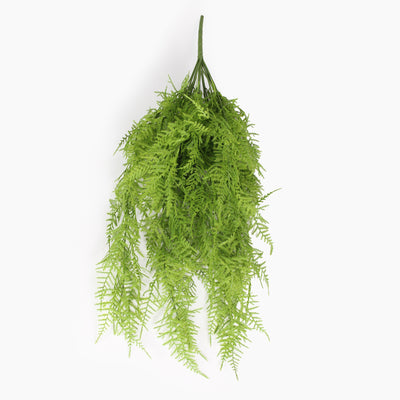 An artificial green fern bush hanging from a single spike, shown against a plain white background.