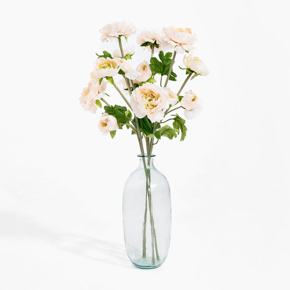 Clear glass vase with white flowers on a white background