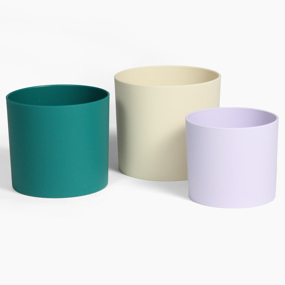 Three colorful plant pots on a white background