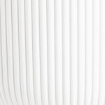 White curtain with vertical pleats on a white background