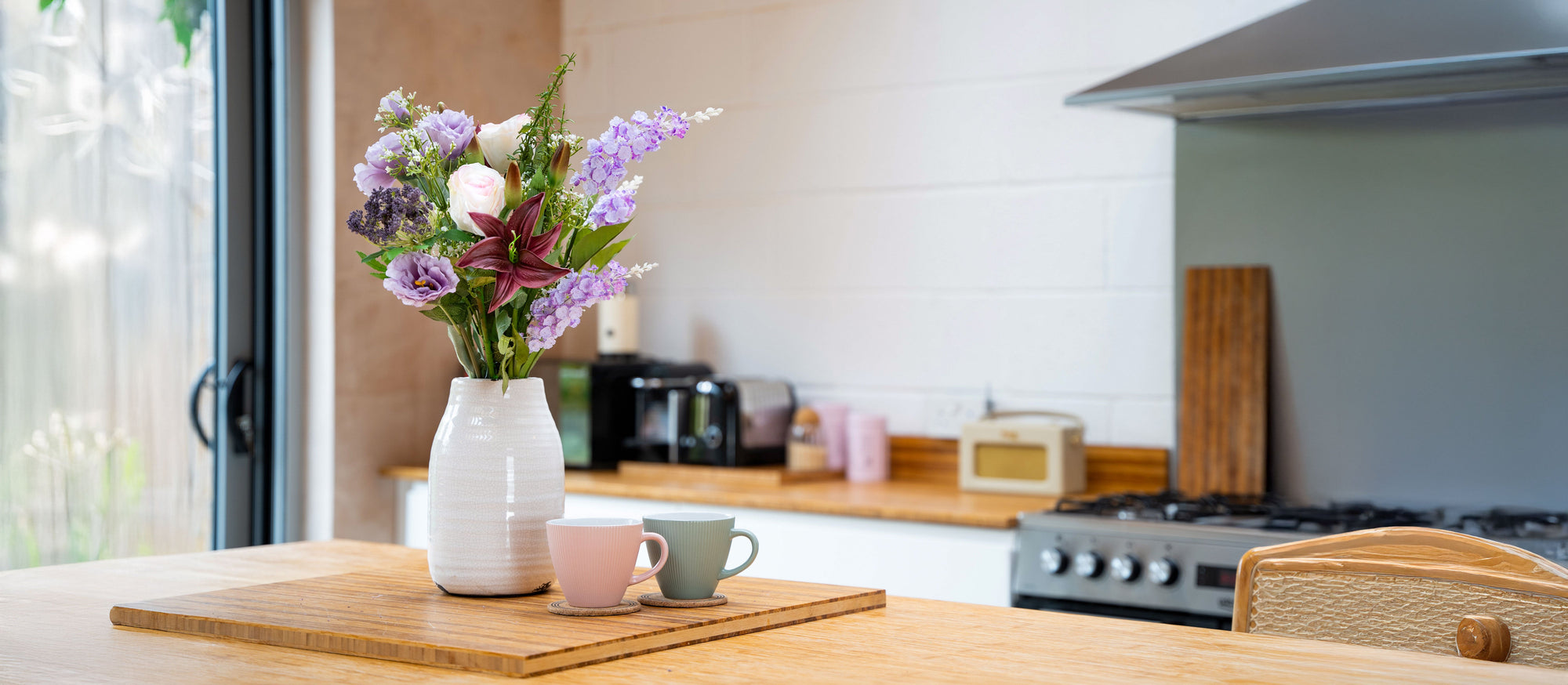 artificial hoya heart in green pot on kitchen shelf