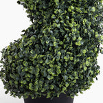 Artificial topiary ball plant in a pot on a white background