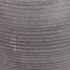 Close-up of a ribbed gray textured ficonstone surface with horizontal grooves and fine speckled material.