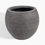 A round, dark gray textured planter pot with horizontal grooved lines and a speckled finish, shown on a clean white background.