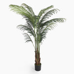 Potted artificial palm plant on a white background